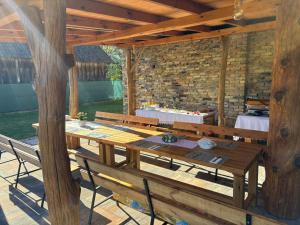 an outdoor patio with a wooden table and benches at Pensjonat Rzepniki in Rzepniki