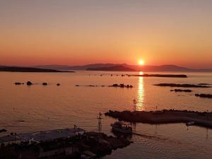 a sunset over a body of water with boats at stelisia2 in Chania +6 photos