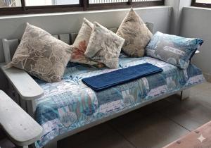 a couch with pillows on it in a room at Anchors Aweigh in Hibberdene +34 photos