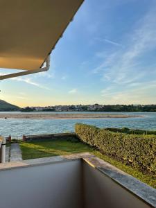 a view of the water from the balcony of a house at CHALET EN PLAYA ROBAYERA in Mogro