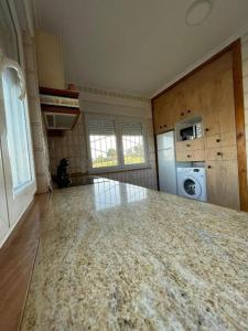 a kitchen with a marble counter top in a room at CHALET EN PLAYA ROBAYERA in Mogro +13 photos