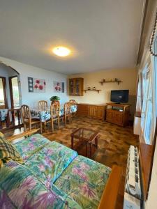 a living room with a bed and a dining room at CHALET EN PLAYA ROBAYERA in Mogro