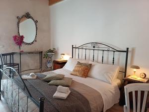 a bedroom with a large bed and a mirror at Agri Experience - Case Gentile in Castelvetrano Selinunte