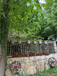 a fence with flower pots on top of it at Vikendica Lenka in Sijarinska Banja