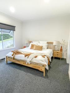 a bedroom with a large bed and a window at Martyr Views in Warburton