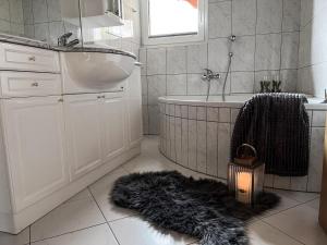 a bathroom with a sink and a fur rug at Residence Chateau in Saas-Fee +16 photos