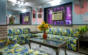 a living room with a couch and a table at Hotel Sunshine - Karol Bagh Budget Stay at New Delhi in New Delhi