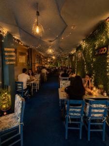a restaurant with tables and people sitting at tables at Teker Suite Hotel in Mersin