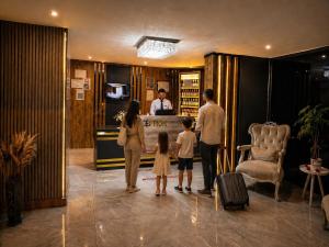 a family standing in the lobby of a hotel at Teker Suite Hotel in Mersin