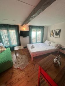 a bedroom with a large bed and a table at La plume d'or in Saint-Étienne