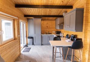 a kitchen with wooden walls and a table and chairs at Wildwood Haven - Killorglin in Killorglin +2 photos