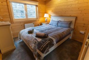 a bedroom with a bed in a wooden cabin at Wildwood Haven - Killorglin in Killorglin
