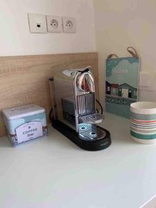 a kitchen appliance sitting on a counter next to a box at Maisonnette de la mer in Hermanville-sur-Mer