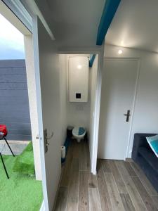 a small bathroom with a toilet in a house at Maisonnette de la mer in Hermanville-sur-Mer +16 photos
