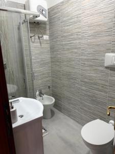 a bathroom with a sink and a toilet and a shower at Casa Alghero Lido in Alghero