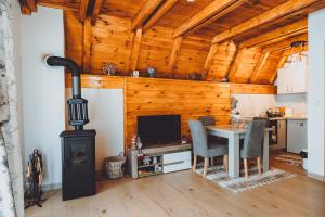 a living room with a wood stove and a table at Etno Villa Popovic in Žabljak