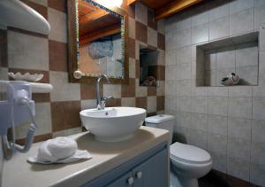 a bathroom with a sink and a toilet at Salty Splash in Klima