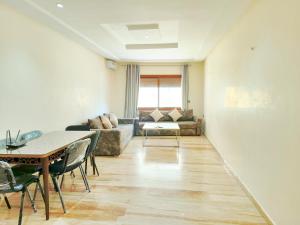 a living room with a couch and a table at Golden Holiday Family Only in Tangier