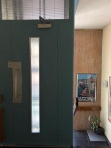 a green door in a room with a window at Seehotel Bären in Brienz