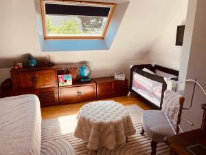 a bedroom with a bed and a table and a window at Maison 4 chambres in Carnac