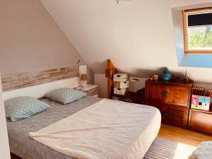 a bedroom with a bed and a dresser and a window at Maison 4 chambres in Carnac