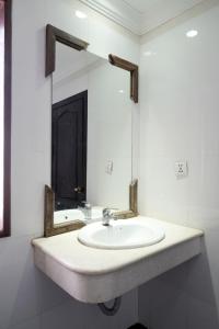 a bathroom with a sink and a mirror at Dara Panha Sak Guesthouse in Siem Reap +25 photos