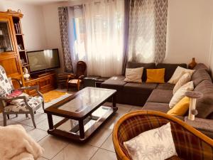 a living room with a couch and a coffee table at Maison 4 chambres in Carnac