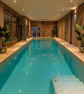 a large swimming pool with blue water in a house at MG Suites & Infinity in Ravels