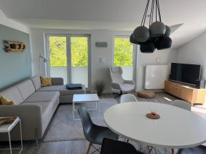 a living room with a couch and a table at Strandperle in Juliusruh