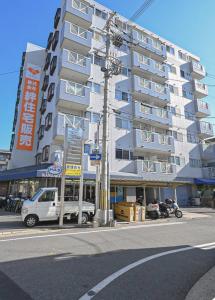 a white van parked in front of a building at High-speed Wi-Fi Station front Kamishinjo in Osaka