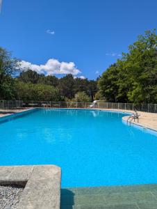 a large blue swimming pool in a park at PHOENIX maison d'hôtes & SPA in Ginasservis