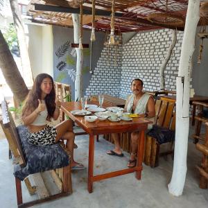 a man and a woman sitting at a table at Blue Vibe in Arugam Bay
