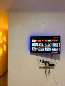 a flat screen tv hanging on a wall at MandA Cozy GuestHouse in Middelburg