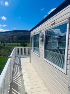 a mobile home deck with a view of the countryside at Blairgowrie in Ballintuim