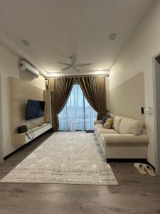 a living room with a couch and a large window at ANTARA Muji Serenity Condo in Putrajaya