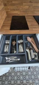 a tray filled with utensils on a table at Gite La Ferme du Château in Cerfontaine