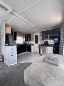 a large kitchen with black and white appliances at Blairgowrie in Ballintuim