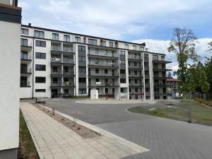 a large apartment building with a street in front of it at MG Apartament City Park in Szczecinek