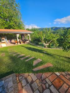 a garden with a stone pathway in the grass at Villa Sara - Apartments & Garden, Kratovo in Kratovo