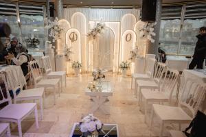 a room with white chairs and tables and flowers at Safir Hotels Silivri in Silivri