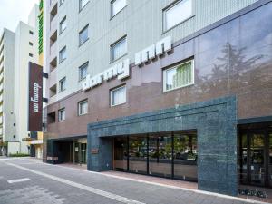 a building with a sign on the side of it at Dormy Inn Hiroshima in Hiroshima
