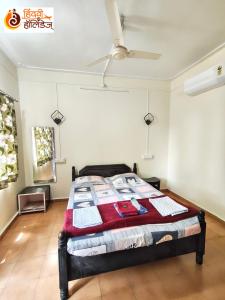 a bedroom with a bed and a ceiling fan at Hotel Shahi Residency in Panhāla