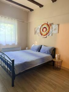 a bedroom with a bed with blue sheets and a window at House on the river in Karlovac +15 photos