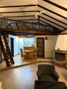 a large living room with a table and a staircase at House on the river in Karlovac