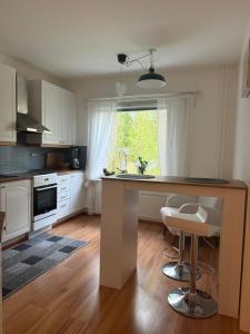 a kitchen with a large island in the middle at LIS Apartment in Naantali