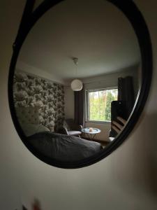 a mirror reflection of a bed in a bedroom at LIS Apartment in Naantali