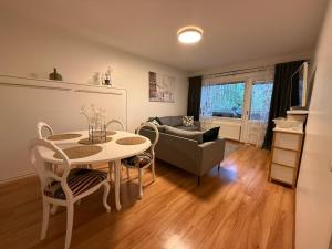 a living room with a table and a couch at LIS Apartment in Naantali