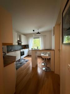 a kitchen with white cabinets and a table and chairs at LIS Apartment in Naantali +10 photos