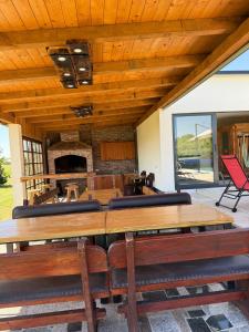 a large dining room with wooden ceilings and a fireplace at House on the river in Karlovac
