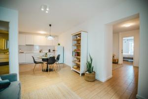 a kitchen and a living room with a table and chairs at Casa do Mar in Ribeira Grande